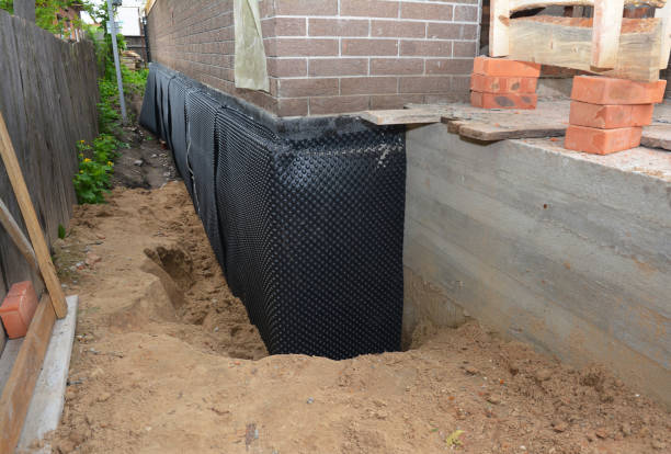 SJ Waterproofing Pros technician performing targeted Emergency Waterproofing assessment in Reed City, MI